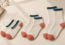 Illustrative comparison of no-show, ankle and crew sock lengths in cream, teal and coral