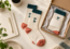 Illustrative employee welcome kit with cream and teal knitted socks, a notebook and a kraft gift box